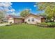 A nicely landscaped single Gathering home with a green lawn under a sunny blue sky at 344 Sandpiper Dr, Casselberry, FL 32707