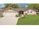 Charming single-story home featuring a well-manicured lawn, and a two car garage at 344 Sandpiper Dr, Casselberry, FL 32707