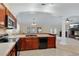 Kitchen featuring tile floors, wood cabinets, and a sink overlooking the living room at 344 Sandpiper Dr, Casselberry, FL 32707