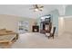 Bright living room featuring a ceiling fan, fireplace, and large TV at 344 Sandpiper Dr, Casselberry, FL 32707