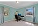 Home office with a computer desk, office chair, two windows, and light-blue walls at 344 Sandpiper Dr, Casselberry, FL 32707
