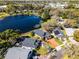 Picturesque aerial view of a lakeside property featuring a screened pool and lush surroundings at 352 Misty Oaks Run, Casselberry, FL 32707