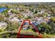 Aerial shot of a home with a screened-in pool and lake access surrounded by lush greenery at 352 Misty Oaks Run, Casselberry, FL 32707