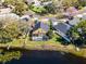 Impressive aerial view showcasing a property with a screened-in pool, lush landscape, and neighborhood setting at 352 Misty Oaks Run, Casselberry, FL 32707
