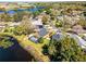 Gorgeous aerial shot of a lakeside home with a screened-in pool and scenic neighborhood views at 352 Misty Oaks Run, Casselberry, FL 32707