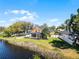 Aerial view of the property showcasing the home, pool, and lake frontage at 352 Misty Oaks Run, Casselberry, FL 32707