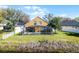 Lovely lakefront backyard showcasing a screened-in pool, a well-maintained lawn, and beautiful water views at 352 Misty Oaks Run, Casselberry, FL 32707