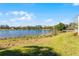 Lush backyard view of the lake and beautiful landscaping, providing a serene outdoor space at 352 Misty Oaks Run, Casselberry, FL 32707