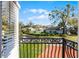 Charming balcony view overlooks lush green lawns, picturesque neighborhood streets, and well-maintained homes at 352 Misty Oaks Run, Casselberry, FL 32707