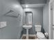 Cozy powder room features modern fixtures and a pedestal sink, maximizing space and style at 352 Misty Oaks Run, Casselberry, FL 32707
