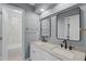 Stylish bathroom featuring double sinks, modern fixtures, and a sleek, tiled shower at 352 Misty Oaks Run, Casselberry, FL 32707