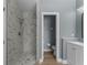 Beautifully renovated bathroom with tiled walk-in shower and separate vanity area for added convenience at 352 Misty Oaks Run, Casselberry, FL 32707