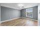 This bedroom offers a ceiling fan, light gray walls, wood floors and a window view at 352 Misty Oaks Run, Casselberry, FL 32707