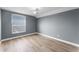 This bedroom offers a ceiling fan, light gray walls, wood floors and a window view at 352 Misty Oaks Run, Casselberry, FL 32707