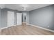 This bedroom features wood floors, light gray walls, and two door entrances at 352 Misty Oaks Run, Casselberry, FL 32707