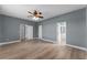 Spacious bedroom with wood-look tile flooring and multiple doorways leading to other rooms at 352 Misty Oaks Run, Casselberry, FL 32707