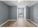 Serene bedroom featuring wood-look flooring, fresh neutral paint, and a bright window at 352 Misty Oaks Run, Casselberry, FL 32707