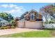 Charming two-story home with a three-car garage, balcony, and well-manicured lawn at 352 Misty Oaks Run, Casselberry, FL 32707