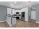 Modern kitchen featuring white cabinets, stainless steel appliances, and stone countertops at 352 Misty Oaks Run, Casselberry, FL 32707