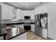 Modern kitchen with stainless steel appliances and marble backsplash at 352 Misty Oaks Run, Casselberry, FL 32707