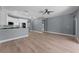 Open living room with kitchen featuring modern white cabinets at 352 Misty Oaks Run, Casselberry, FL 32707