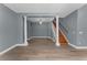 Spacious living room featuring beautiful wood floors and staircase at 352 Misty Oaks Run, Casselberry, FL 32707