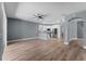 Open concept living room with kitchen and wood-style tile flooring at 352 Misty Oaks Run, Casselberry, FL 32707