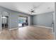 Open living area with tile floors, ceiling fan, and access to the screened-in patio at 352 Misty Oaks Run, Casselberry, FL 32707