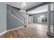 Open living room showcases staircase, wood floors, and bright lighting at 352 Misty Oaks Run, Casselberry, FL 32707