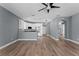 Open concept living room with kitchen featuring modern white cabinets at 352 Misty Oaks Run, Casselberry, FL 32707