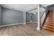 Open living space with wood floors, decorative columns, and staircase to the second floor at 352 Misty Oaks Run, Casselberry, FL 32707
