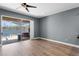 Bright living room with sliding glass doors to pool and water view at 352 Misty Oaks Run, Casselberry, FL 32707