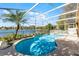 Beautiful screened-in pool with lush landscaping and stunning waterfront views at 352 Misty Oaks Run, Casselberry, FL 32707