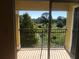 Scenic view from a balcony featuring lush greenery and a serene body of water under a clear sky at 3714 Palm Desert Ln # 5337, Orlando, FL 32839