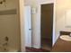 Bathroom showcasing tiled walls, a shower/tub combination, and an open doorway, seamlessly blending style and function at 3714 Palm Desert Ln # 5337, Orlando, FL 32839