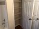 Bathroom with a bathtub/shower and a glimpse into closet with open, wire shelving at 3714 Palm Desert Ln # 5337, Orlando, FL 32839