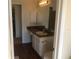 Bathroom featuring a vanity area with a sink and mirror, and a glimpse into an adjacent room at 3714 Palm Desert Ln # 5337, Orlando, FL 32839