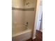 The bathtub in the bathroom is a pristine white, complemented by modern chrome fixtures and white tile at 3714 Palm Desert Ln # 5337, Orlando, FL 32839