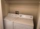 Convenient in-unit laundry room with washer, dryer, and shelving for storage solutions at 3714 Palm Desert Ln # 5337, Orlando, FL 32839