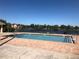 Community pool overlooks a lake, offering a picturesque setting for recreation and relaxation at 3714 Palm Desert Ln # 5337, Orlando, FL 32839