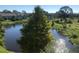 Scenic view from a balcony featuring lush greenery, a serene body of water, and nearby buildings at 3714 Palm Desert Ln # 5337, Orlando, FL 32839