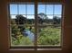 A picturesque view from the window features a serene stream surrounded by vibrant greenery and lush trees at 3714 Palm Desert Ln # 5337, Orlando, FL 32839