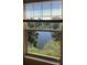 Picturesque view of a serene pond and lush greenery from the window, creating a tranquil and relaxing atmosphere at 3714 Palm Desert Ln # 5337, Orlando, FL 32839