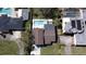 Aerial view shows waterfront home with a private pool and dock, complemented by lush landscaping and serene surroundings at 382 Riverside Dr, Ormond Beach, FL 32176