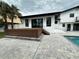 Backyard with deck, patio, and steps leading to a refreshing pool at 382 Riverside Dr, Ormond Beach, FL 32176