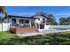 Backyard featuring a pool, deck, and modern architectural design elements at 382 Riverside Dr, Ormond Beach, FL 32176