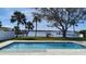 Backyard swimming pool with a waterfront view, palm trees and a meticulously maintained lawn at 382 Riverside Dr, Ormond Beach, FL 32176