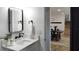 Modern bathroom featuring a black framed mirror, white marble countertop, and a glimpse into adjacent room at 382 Riverside Dr, Ormond Beach, FL 32176