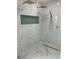 Sleek marble shower with rainfall head and integrated teal tiled shelving at 382 Riverside Dr, Ormond Beach, FL 32176