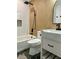 Stylish bathroom featuring a modern vanity, dark fixtures, and a shower-tub combo with vertical wood and tile accents at 382 Riverside Dr, Ormond Beach, FL 32176